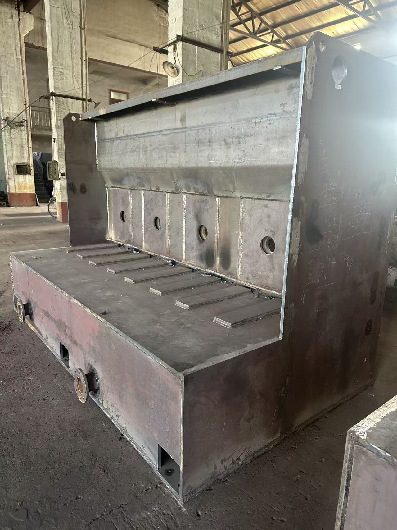 Large welded machine frame during fabrication in the workshop