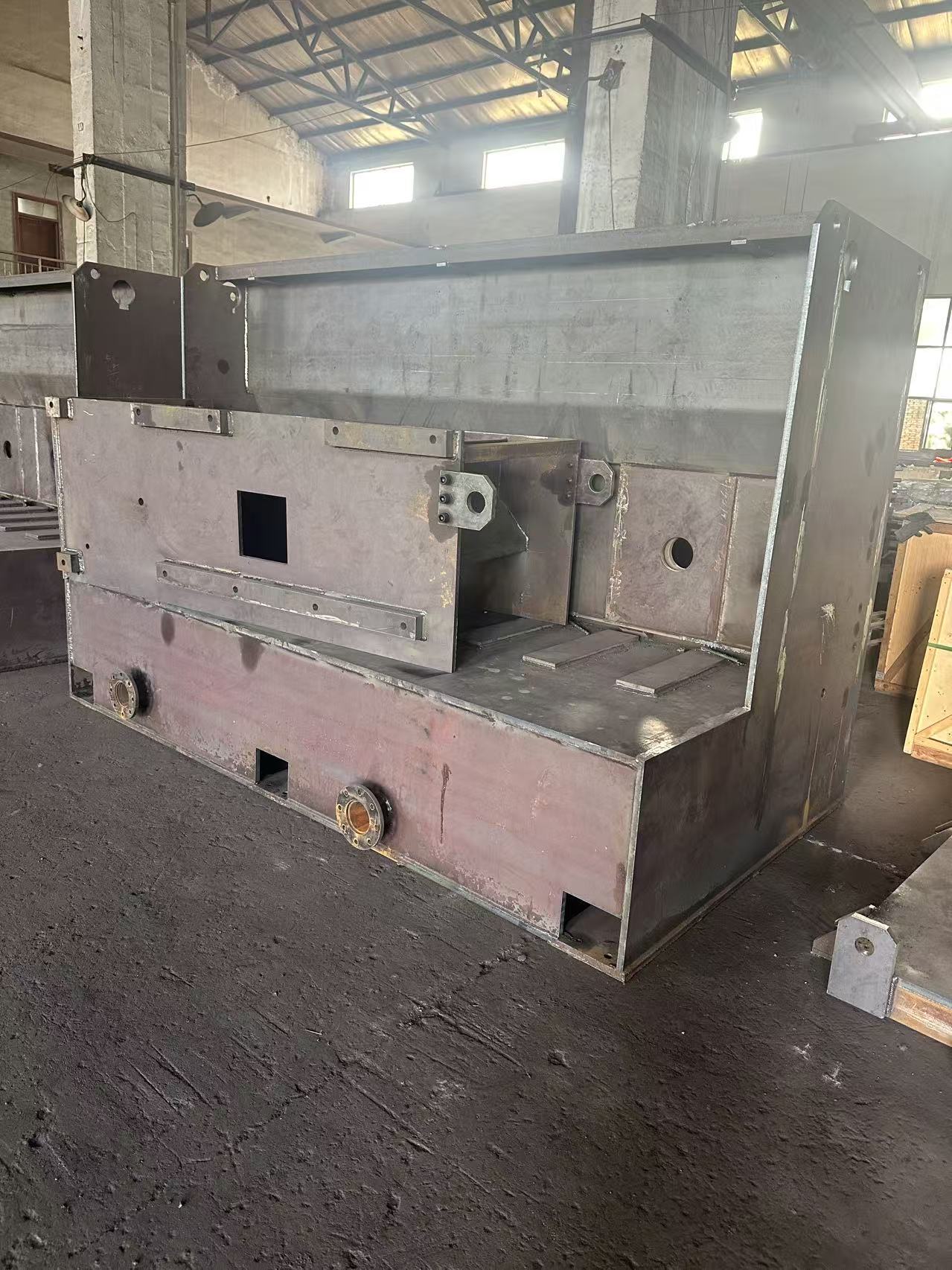 Custom steel equipment frame with welded brackets and machined openings